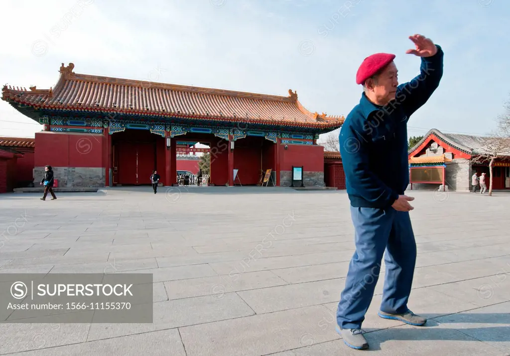 Morning exercises in Jingshan Park in Beijing, China. Behind the man: North Gate of Jingshan Park.