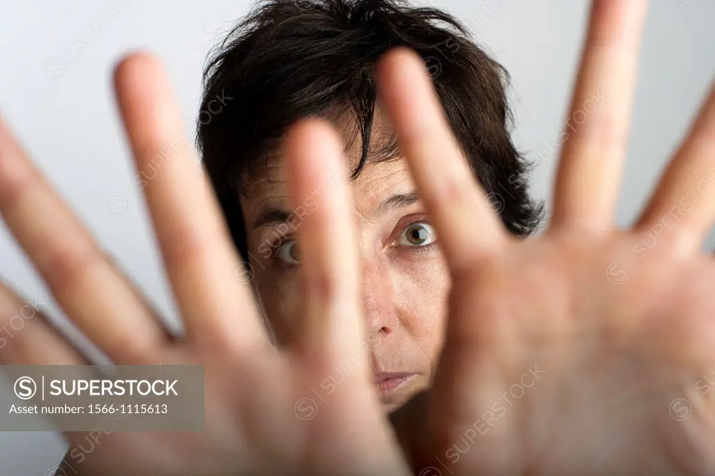 Woman covering camera with her hands