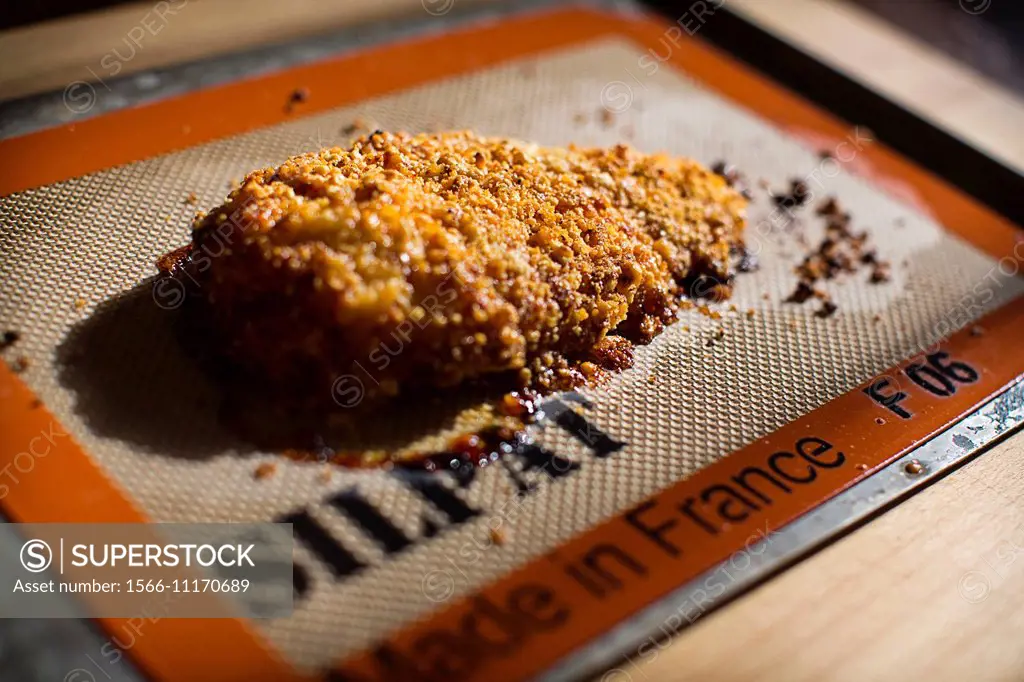 parmesan crusted chicken breasts al forno on baking tray.