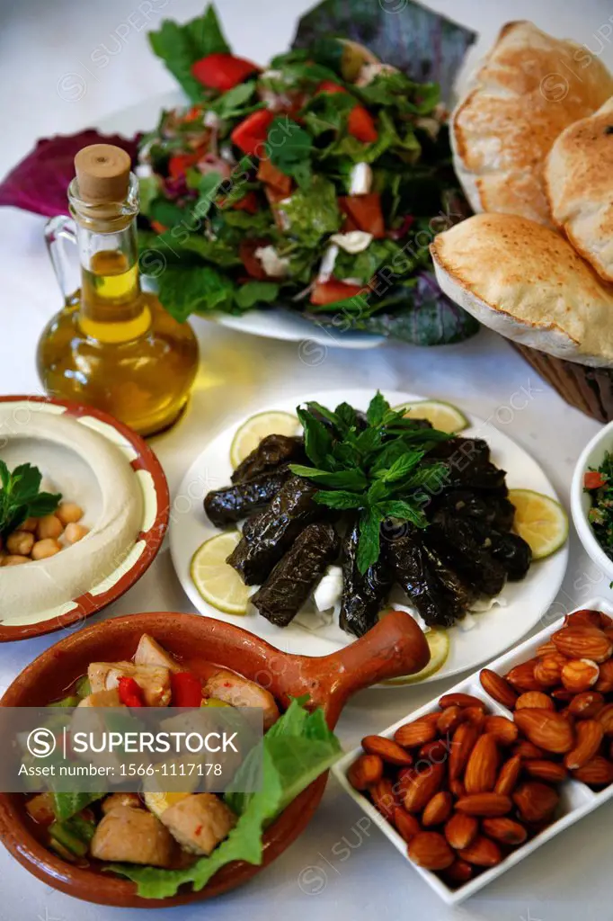 Mezzes hummus, salad, cow testicles, almonds, tabboulehat the Lebanese House restaurant in Jerash, Jordan