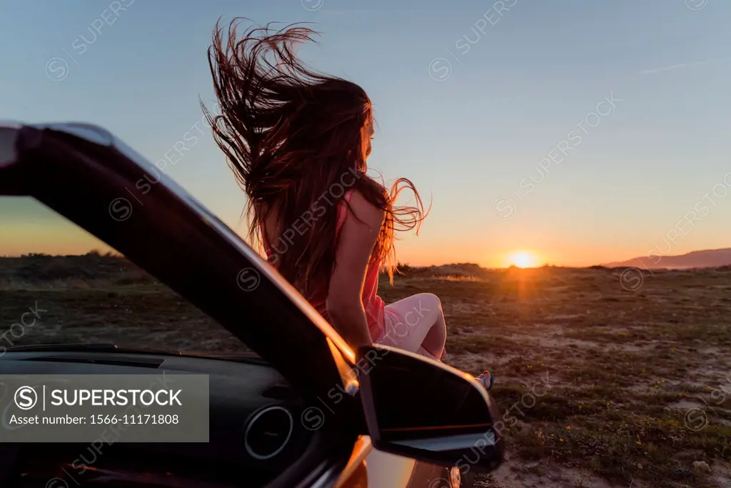 Young woman in a convertible car. Tarifa, Cadiz, Andalusia, Spain, Europe.