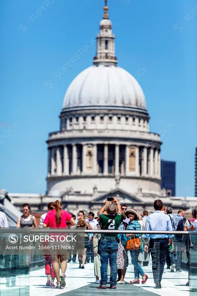 People Crossing The Millennium Bridge With St Paul´s Cathedral In The Backround, London, England.
