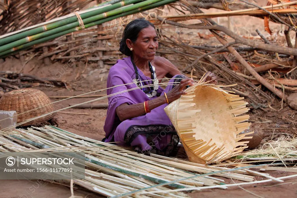 Kamar woman making baskets with dry bamboo strips, Matal Village, Chhattisgarh, India.