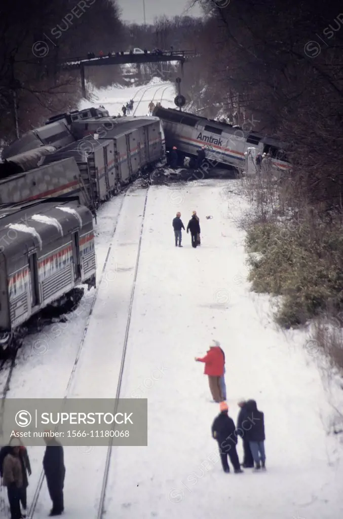 Investigators examine the scene of a fatal train crash in the cold snow in Silver Spring, Md.