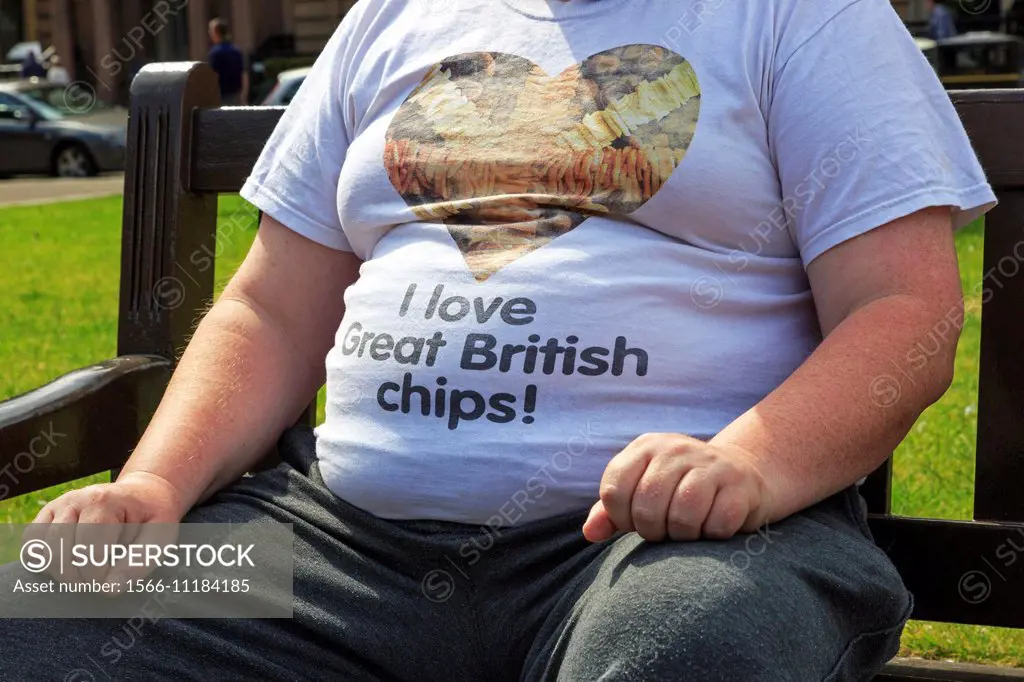 Overweight man wearing a tee shirt advertising chipped potatoes, Glasgow, Scotland, UK.