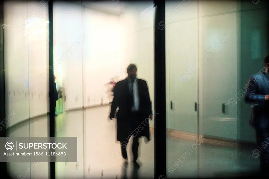Unrecognizable Businessman walking down the hall of an office building in the city of London, England, UK