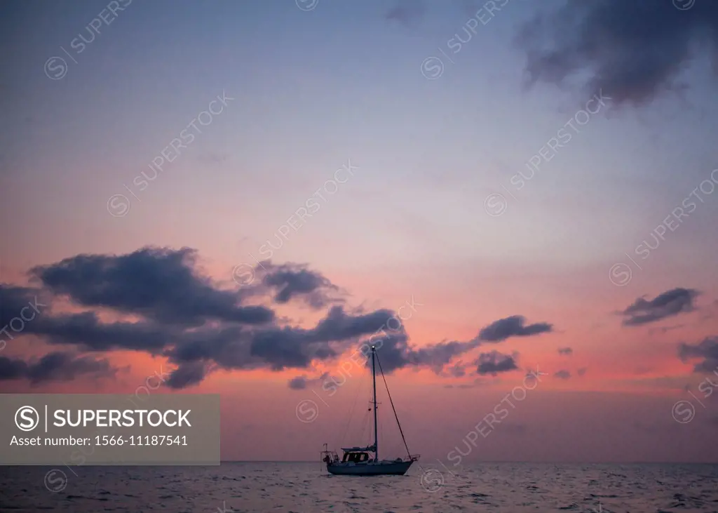 Belize, sailboats on the Caribbean at Sunset.