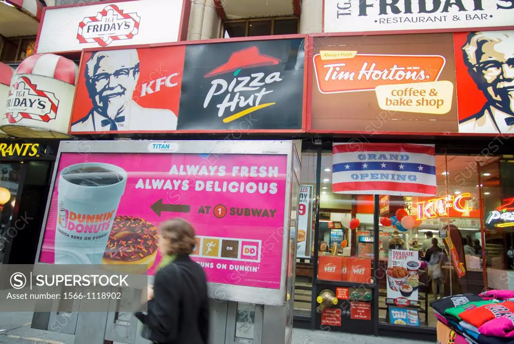 Signs for an assortment of fast food franchises located in one storefront in New York Tim Hortons competitor Dunkin Donuts joins the visual clutter wi...