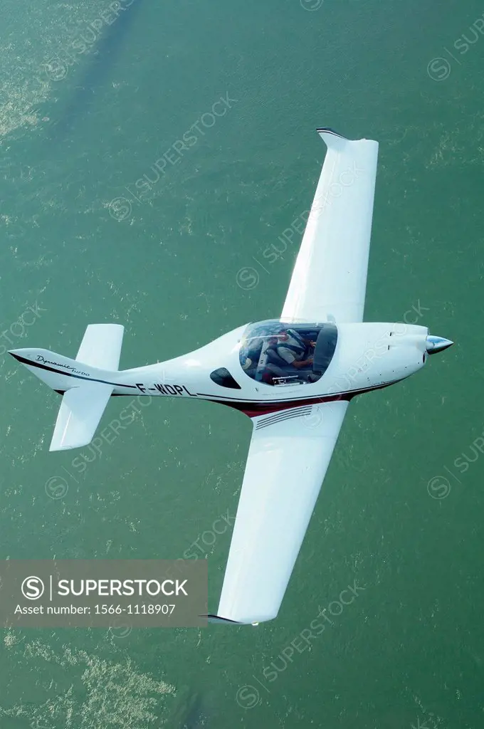Small sport European LSA Aerospool Dynamic Turbo plane flying over Rhein river, Alsace, France