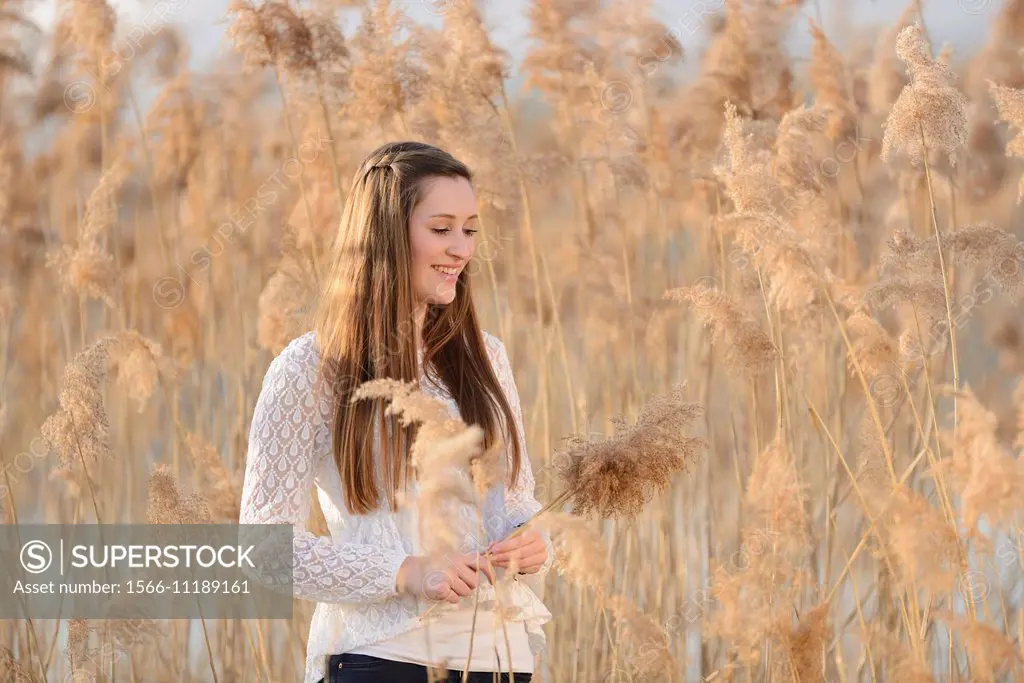 Portrait of a good looking young woman in the reeds on a sunny day in early spring.