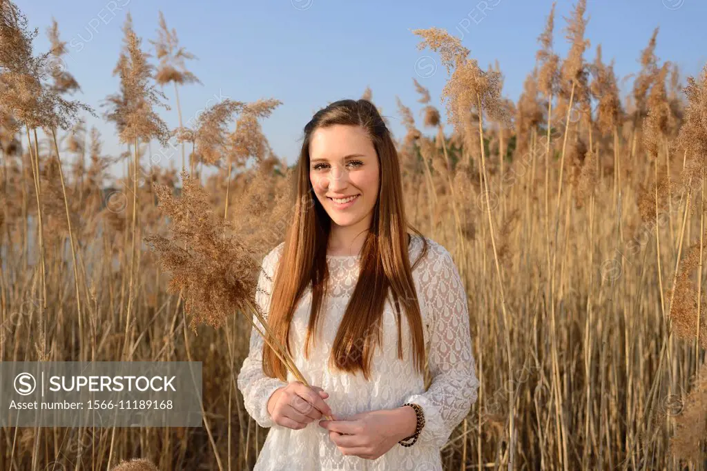 Portrait of a good looking young woman in the reeds on a sunny day in early spring.