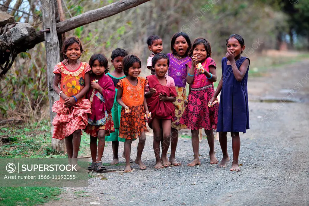 Tribal children walking on village road. Baiga tribe. Karangra Village, Chhattisgarh, India.