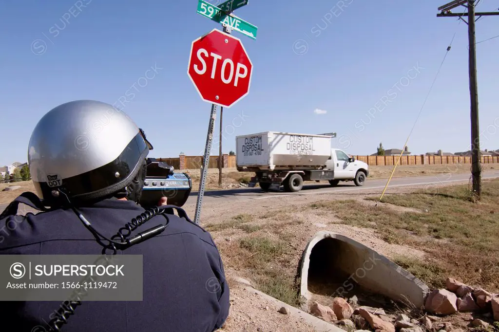 Police officers use radar to check the speed of motorists in Greely, Colorado, USA, October 3, 2011.
