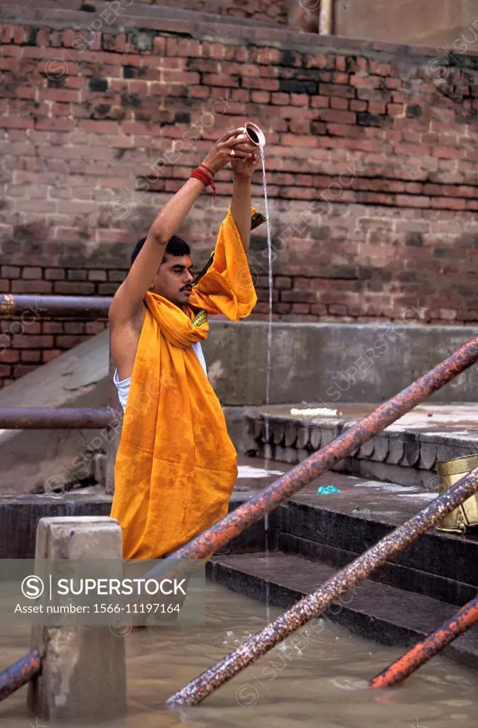 Man taking ritual bath in the river Ganga. Ganges. The holy city of Varanasi, India.