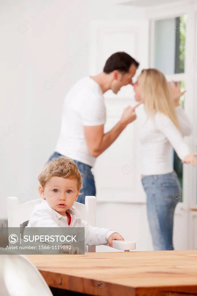 Parents arguing in front of their young child