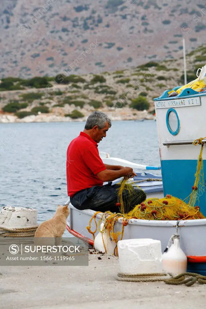 Fisherman at the harbour in Panormitis, Symi, Greece