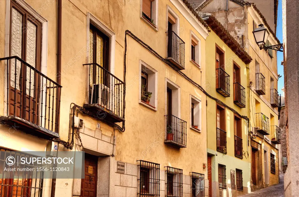 Rustc houses and narrow cobblestone street, Madrid, Spain
