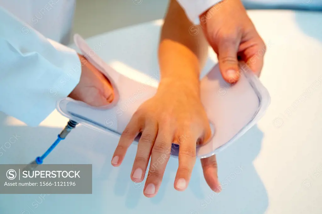 Researcher placing a patient splint prototype built with variable stiffness textile and automatic generation by vacuum lamination  It is being used as...
