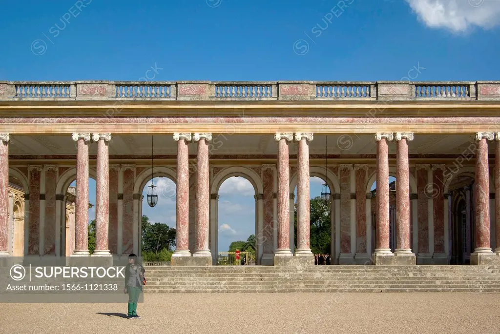 Colonnade in pink Languedoc marble at the Grand Trianon of Versailles Palace, combining French and Italian architectural styles.