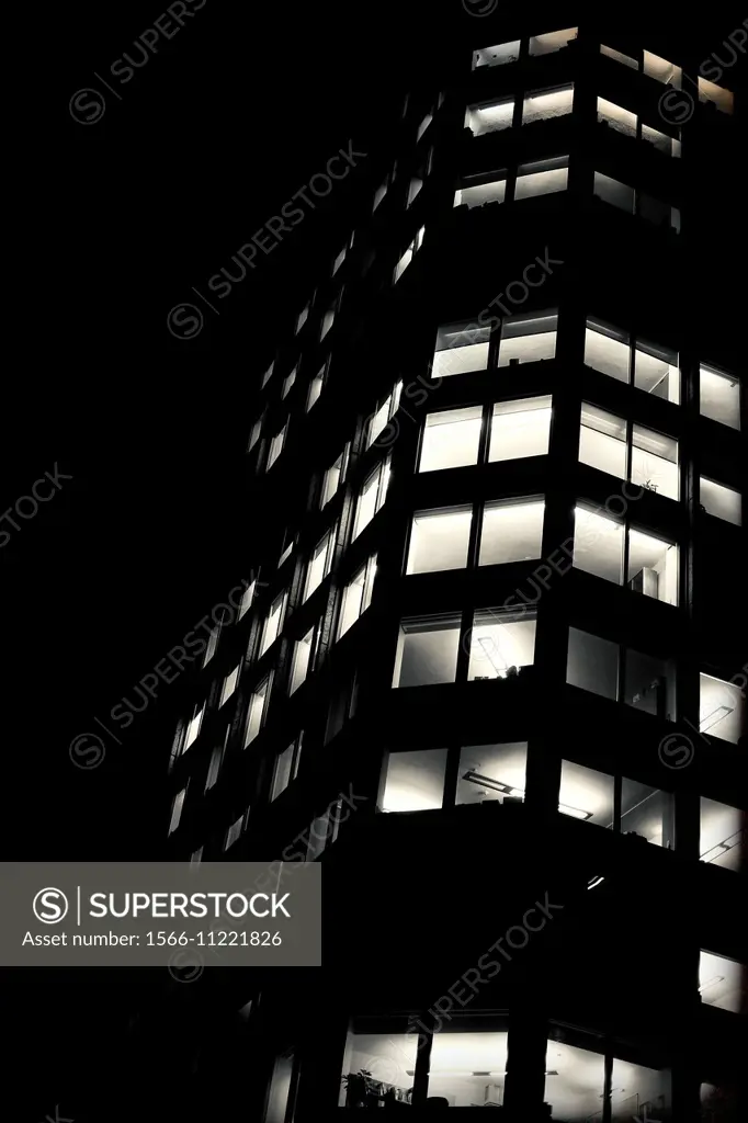 Closeup of the windows of an office building at night with all the lights on in. London, England, UK
