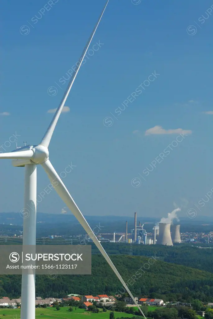 Aerial view of an alternator and propeller of a wind turbine with on background coal electricity power-plants at Carling Centrale Emile Huchet, Longev...