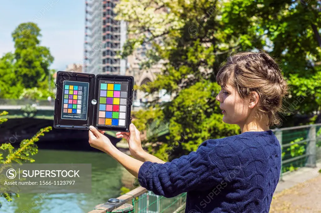 Girl holding photographic color rendition chart, Strasbourg, Alsace, France