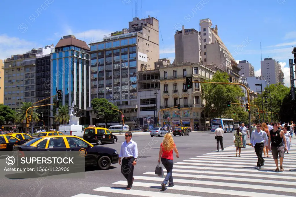 Argentina, Buenos Aires, Avenida 9 de Julio, street scene, urban housing, apartment buildings, high rise, traffic, car, taxi, cab, Hispanic, man, woma...