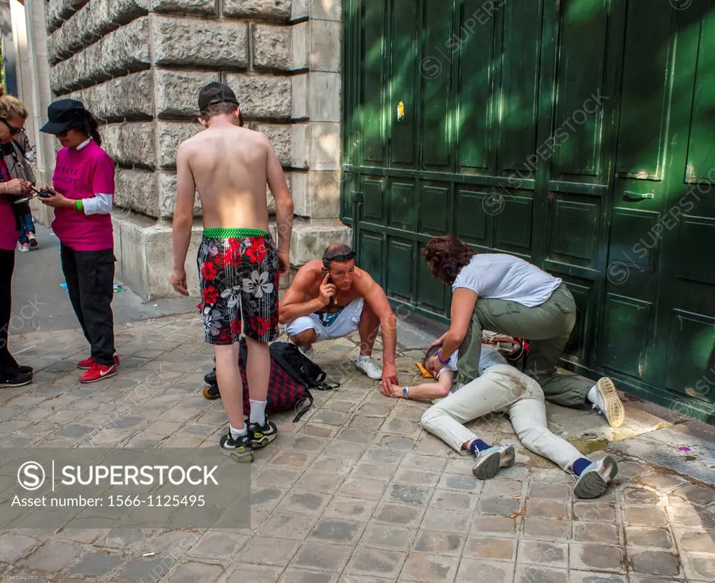 Paris, France, Teenager Laying Unconscience on Sidewalk, passed out from Alcohol Abuse, during Gay Pride LGBT