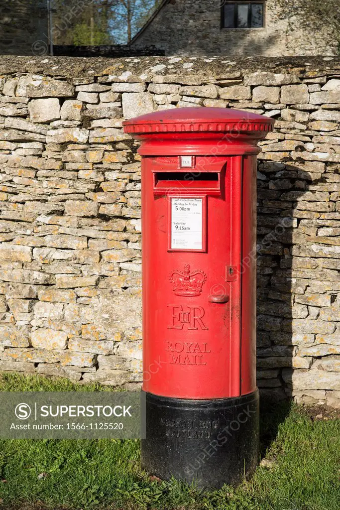 Red postbox by a drystone wall Tackley Oxfordshire England UK
