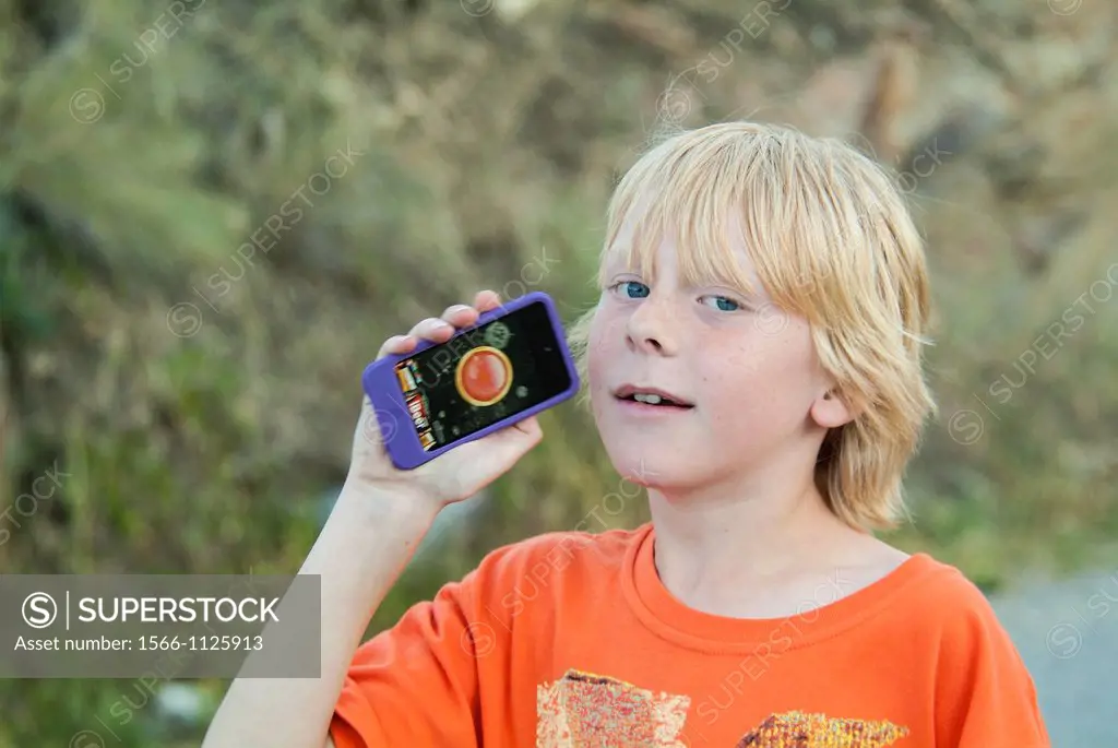 A boy, 10, shows his electronic device