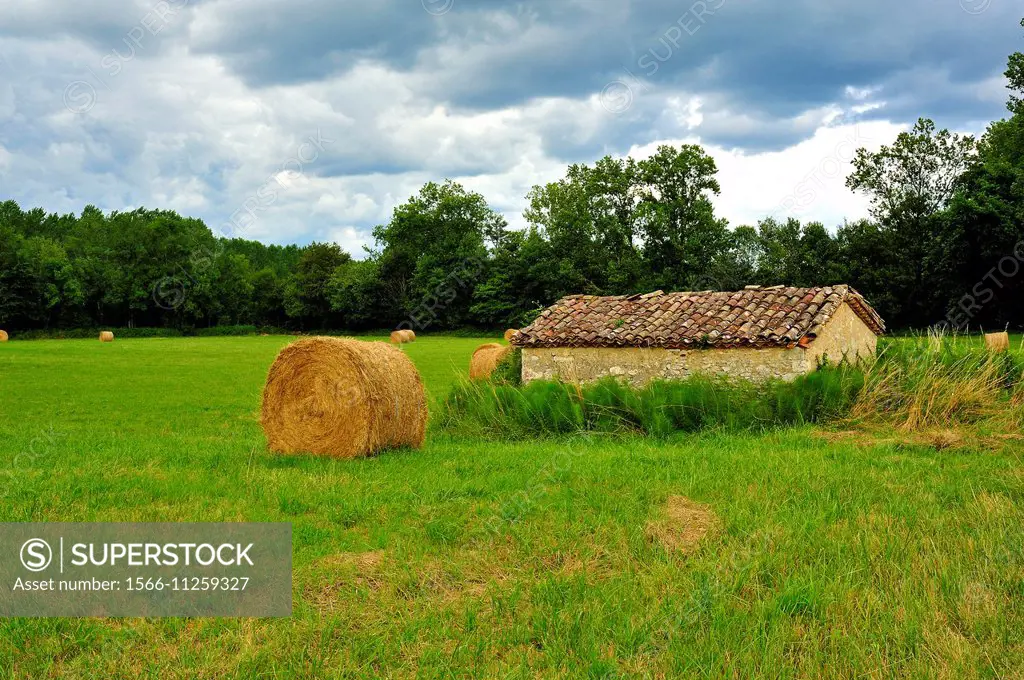 Hay bales and farm building, Lot-et-Garonne Department, Aquitaine, France.