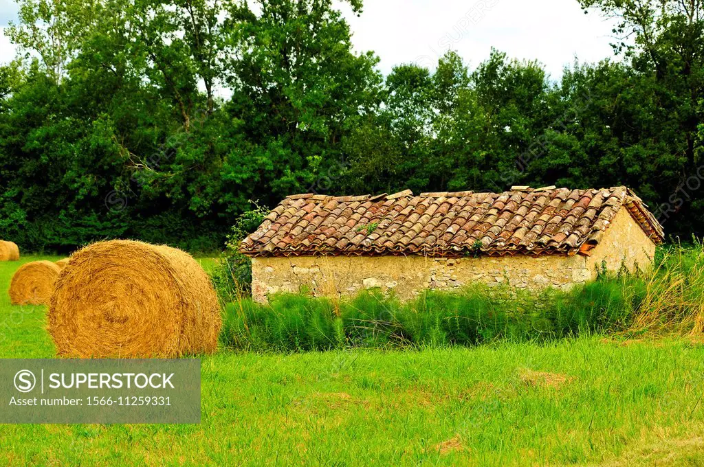 Hay bales and farm building, Lot-et-Garonne Department, Aquitaine, France.