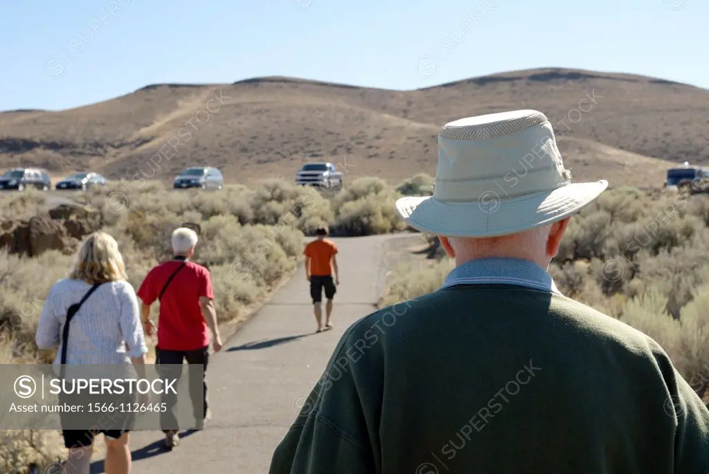 Tourists head back to their vehicles at a scenic outlook off Interstate 90 near Ellensburg, Washington, United States.