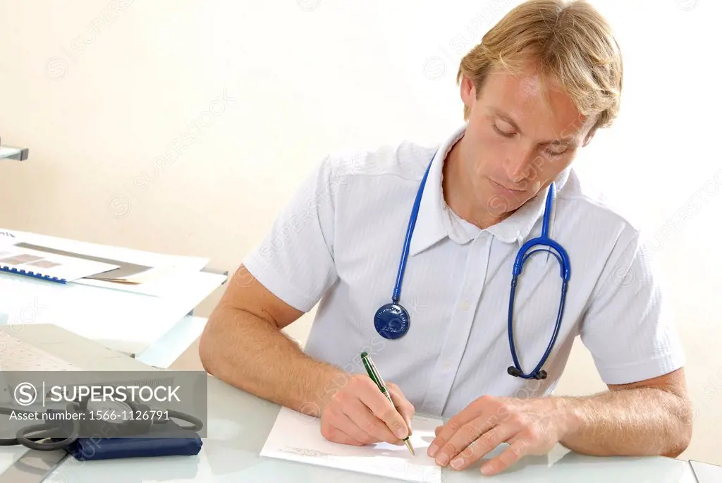 Doctor writing notes at his desk