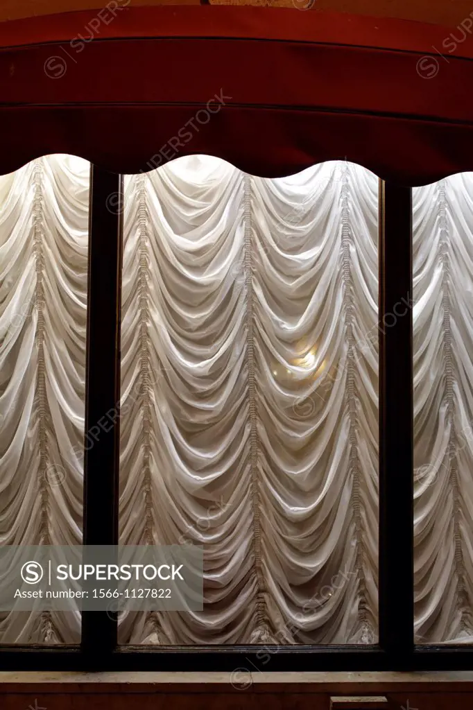 hotel window with elegant draped curtains at night in rome italy