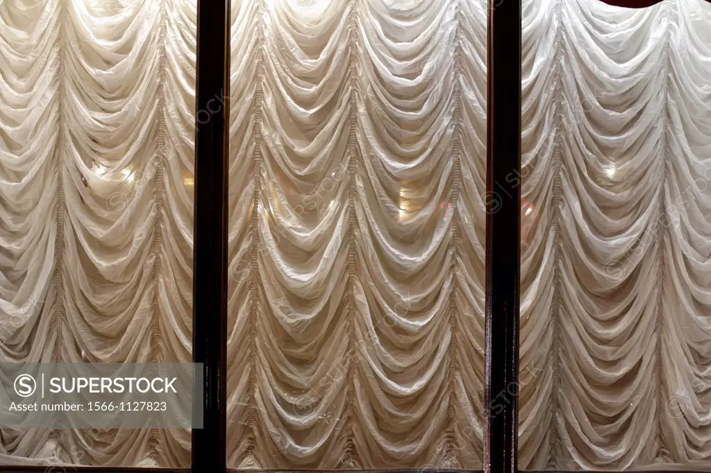 hotel window with elegant draped curtains at night in rome italy