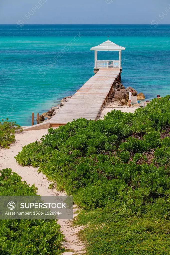 A walkway to a dock and gazebo with the ocean in Nassau, Bahamas