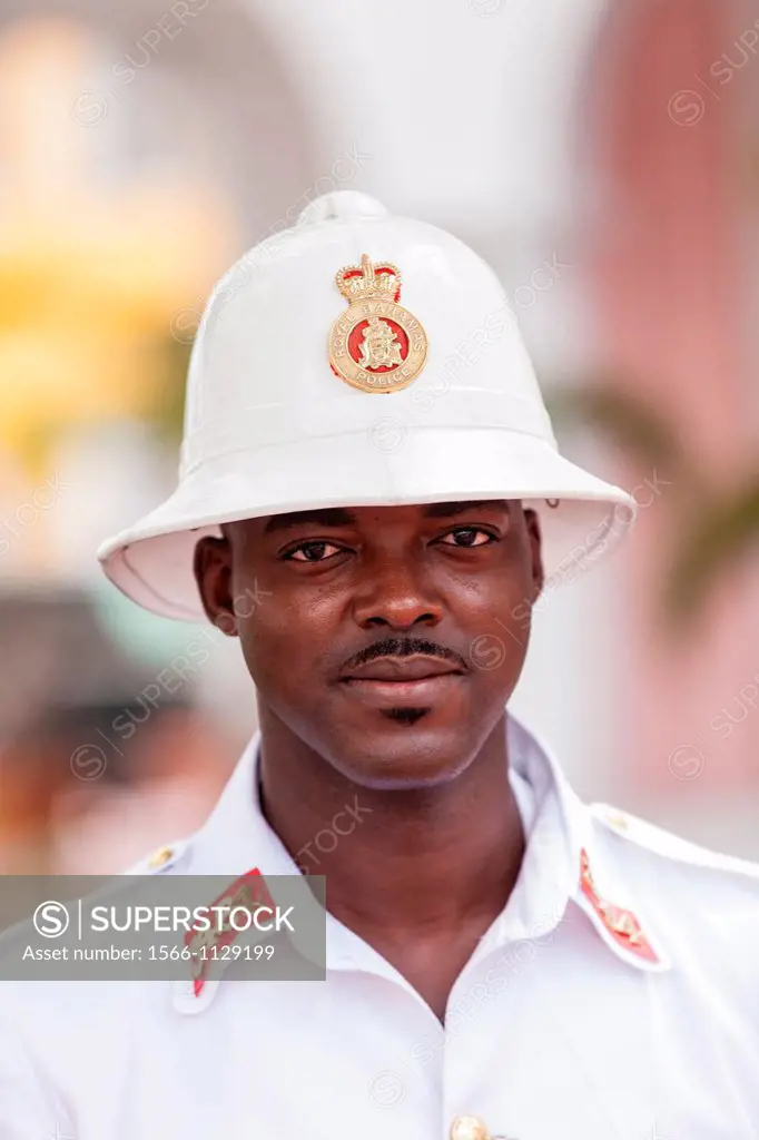 A member of the Royal Bahamas Police wearing a Wolseley pith helmet patrols Parliament Square Nassau, Bahamas