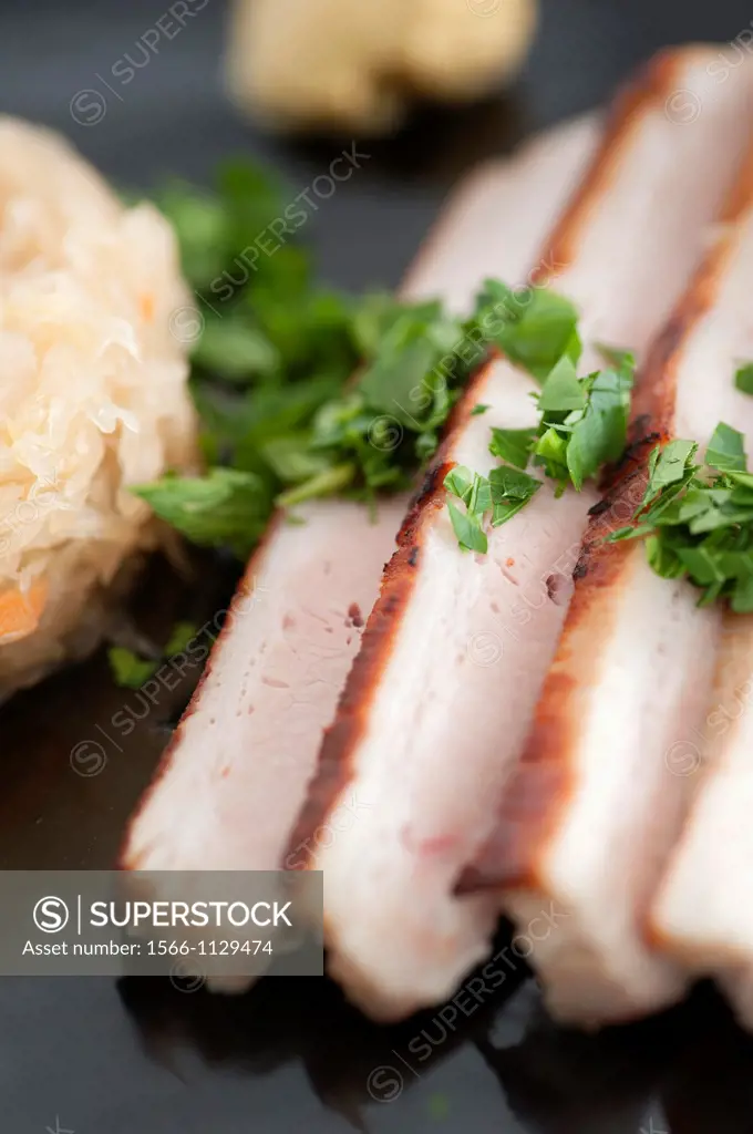 Traditional german food, roasted pork with sauerkraut  Served with mustard and parsley
