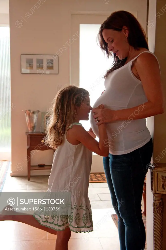 Expecting mother with her daughter