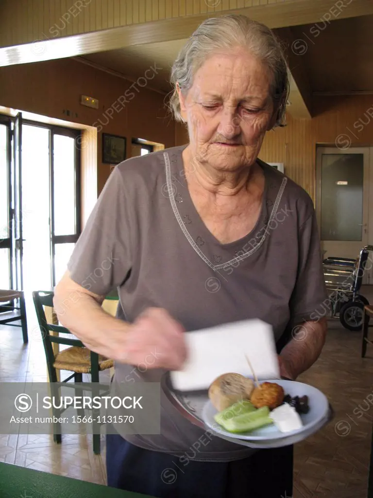 Old lady serving a simple Meze, Galatas Village Kafeneio, Crete, Greece
