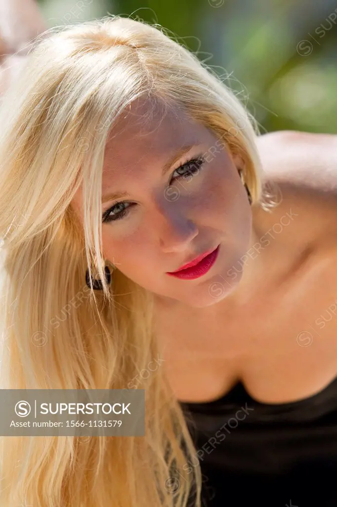 Blonde young girl looking at the camera