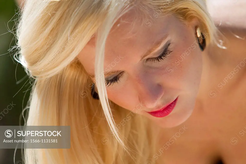 Blonde young girl looking down