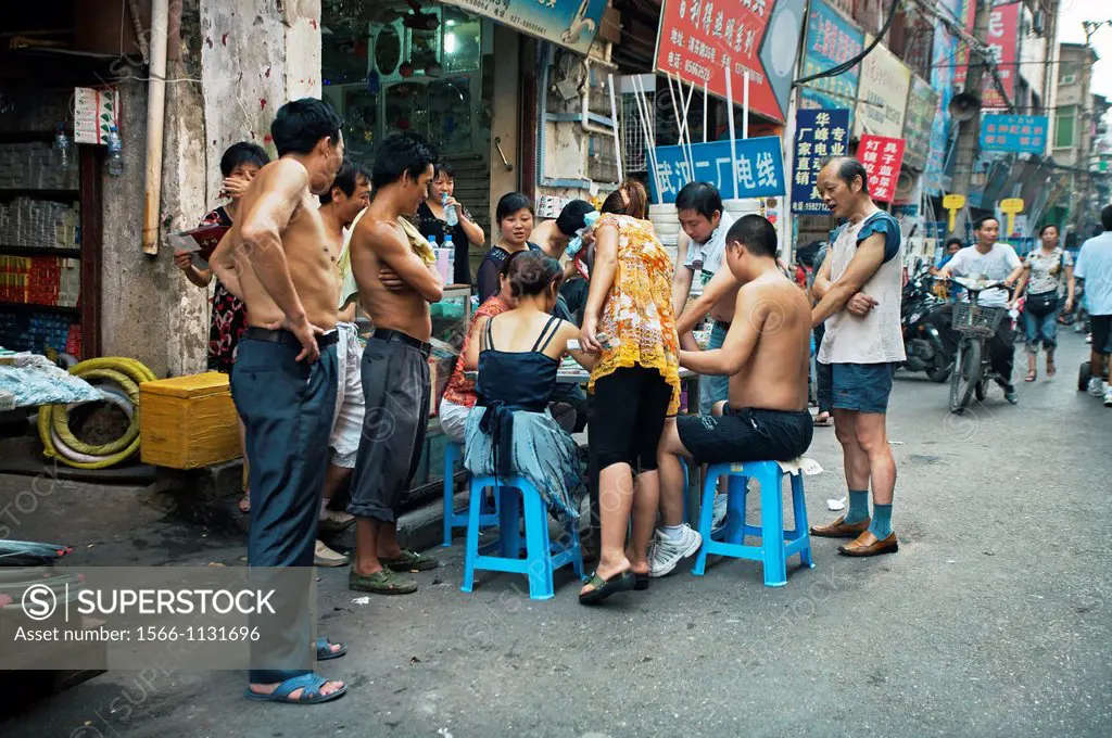 Playing cards on the street, Yangtze River, China.