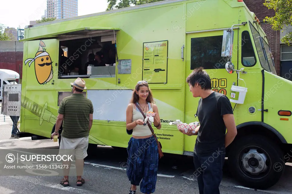 Hungry attendees to the AfroPunk Festival in Commodore Barry Park in Brooklyn in New York enjoy eats from Domo Taco truck at the food truck festival T...
