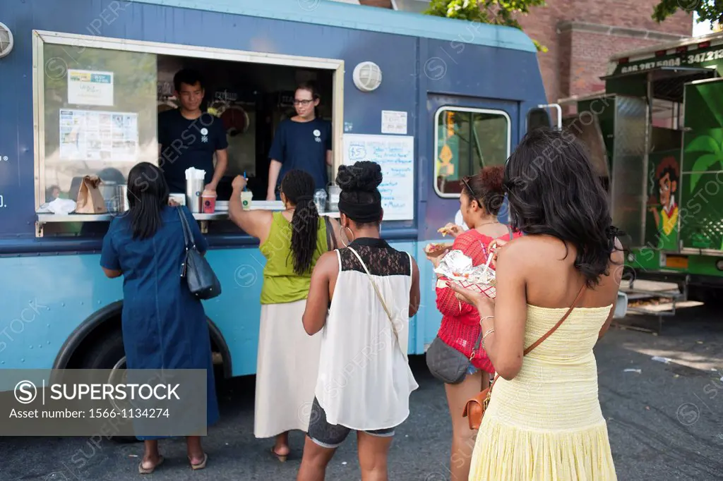 Hungry attendees to the AfroPunk Festival in Commodore Barry Park in Brooklyn in New York enjoy iced drinks from the Kelvin Slush truck at the food tr...