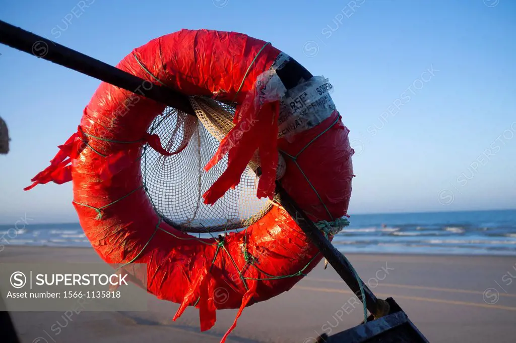 Old red float fisherman on the beach at Doñana Natural park, Huelva, Andalusia, Spain, Europe