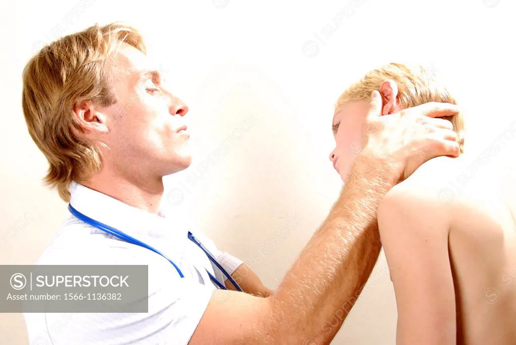Paediatric examination  Paediatrician examining a young boy´s neck vertebrae