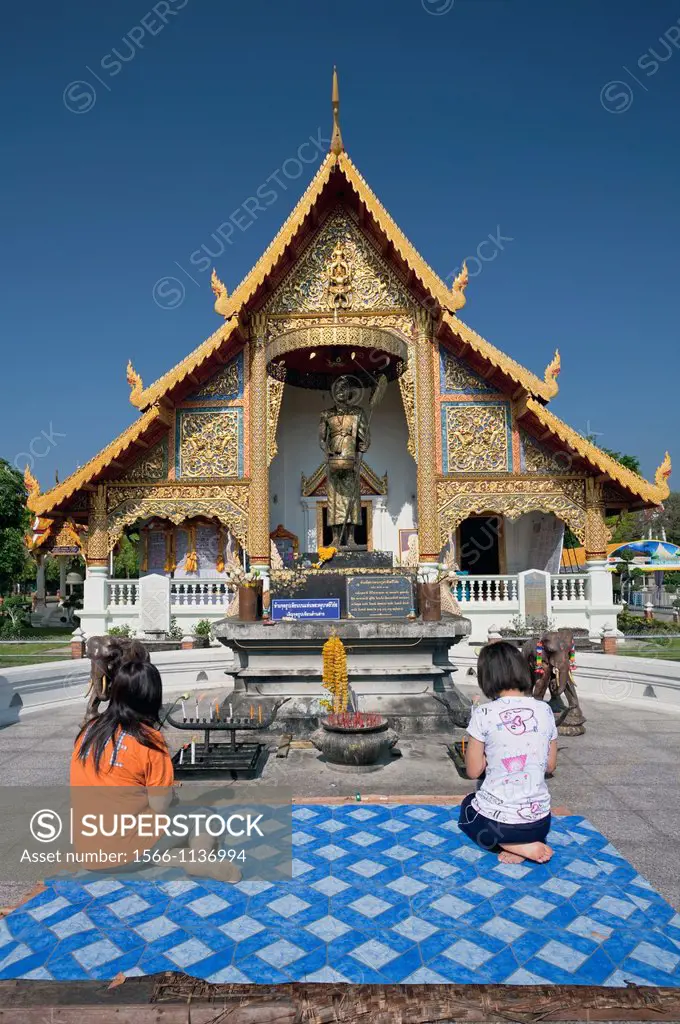 Women in prayer outside Wat Phra Singh, Chiang Mai, Thailand