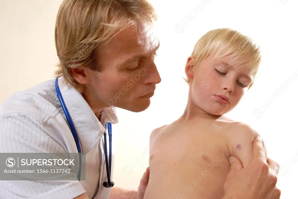 Paediatric examination  Paediatrician examining a young boy´s arm stitches